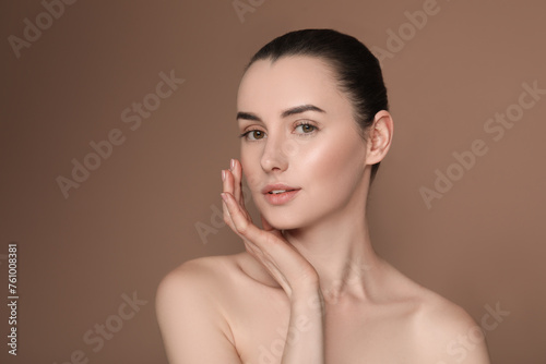 Portrait of beautiful young woman on brown background
