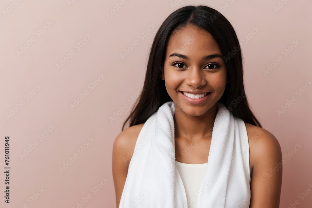Beautiful young black woman with a towel on a pink background with copy space. Beautiful young black woman with a towel on a pink background with copy space.