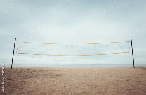 Beach volleyball net. Summer outdoor activities. Play sports on the sandy beach with seascape view.
