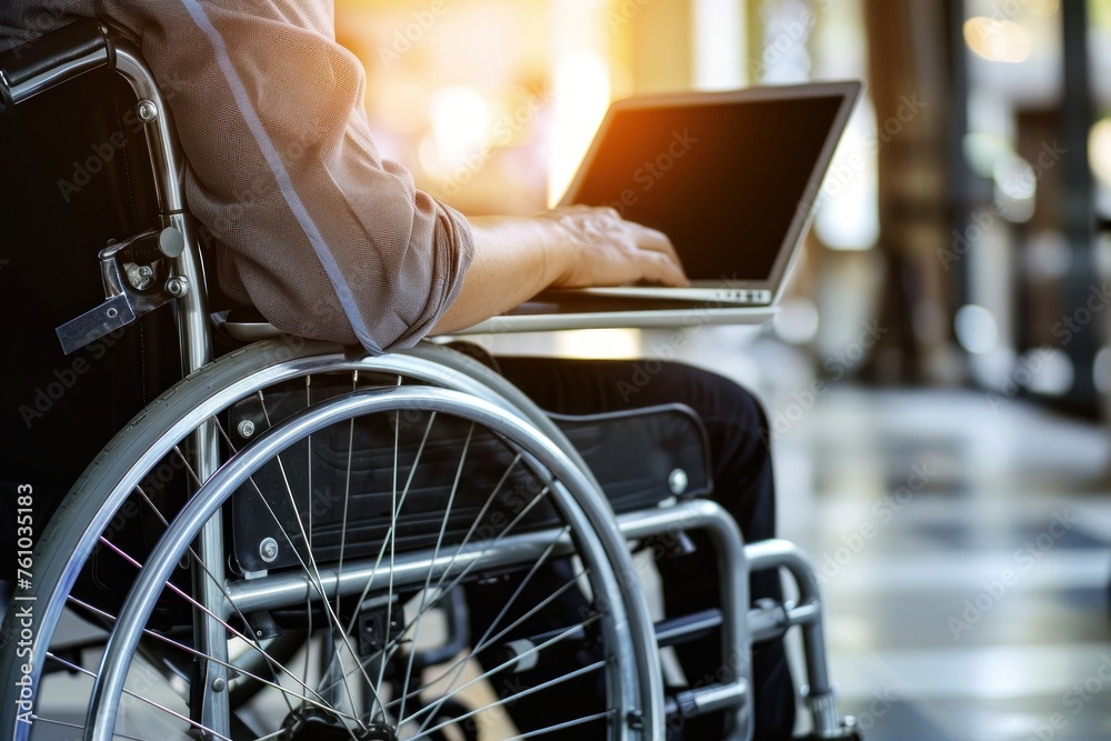 Man in wheelchair working on laptop.. Man in wheelchair working on laptop..