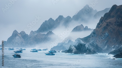 Mystical landscape of jagged peaks shrouded by rolling fog above the ocean, evoking a sense of isolation photo