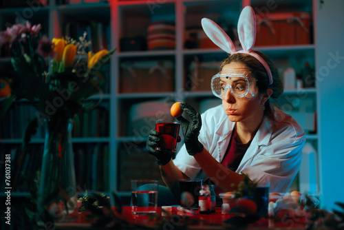 Housewife with Bunny Ears Using Food Coloring for Easter Eggs . Funny lady dyes the eggs according to an original method 