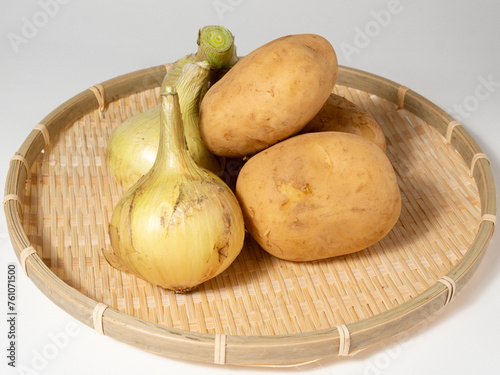 onions and potatoes in a wooden bowl