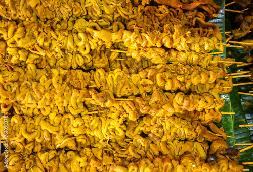 Chicken intestine satay, traditional food from Indonesia. Chicken intestines are skewered with bamboo then fried, eaten as a snack or with rice. photo