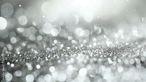 A silver and white background with many small silver circles. The circles are scattered all over the background, creating a sense of movement and energy. The image evokes a feeling of excitement