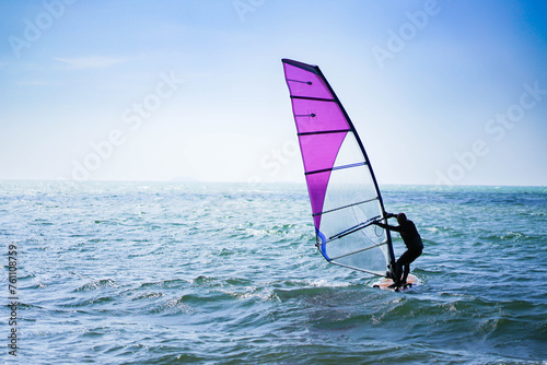 Windsurfers enjoy riding the waves during the sunny summer months © TEEREXZ
