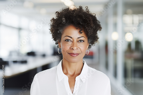 portrait of mature black businesswoman looking at camera in the bright office