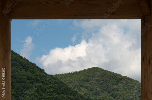 View of the green mountain and white cloud in the frame of the pavilion