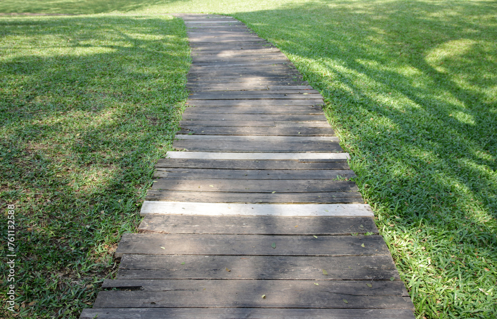 A row of wooden walkways in the garden with natural background