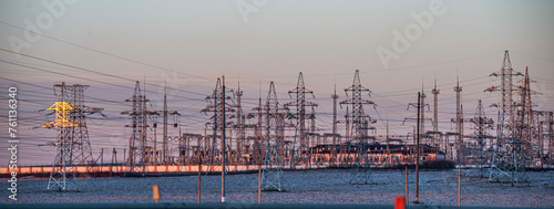 High-voltage direct current line Power lines at sunset, sun rays. High voltage tower against the sky. Energetics