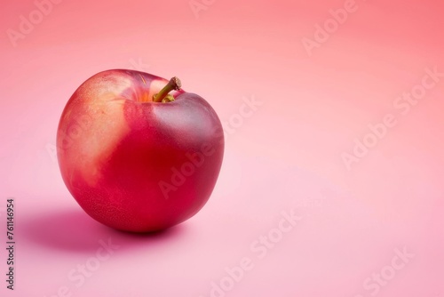Red Apple on Pink Surface