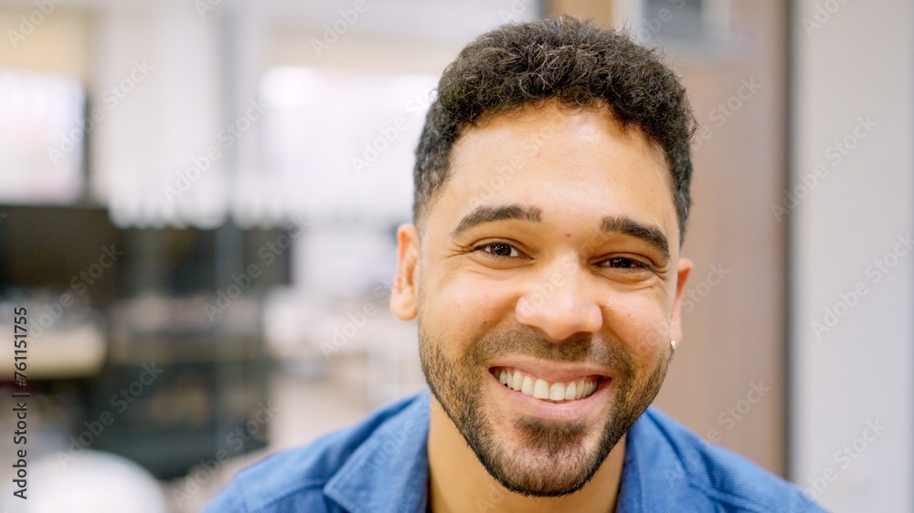 Hispanic man smiling at camera working in a coworking Hispanic man smiling at camera working in a coworking