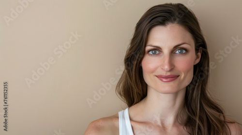 Woman portrait in her mid thirties isolated from a beige copyspace background