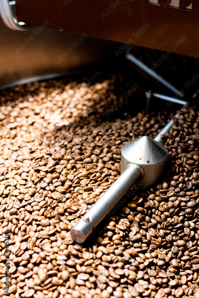 coffee bean swirling in the roaster while sunlight hits it coffee bean swirling in the roaster while sunlight hits it