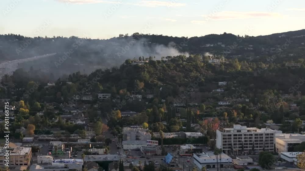 Fire in the hills above multi-million dollar homes in Encino, California - aerial Fire in the hills above multi-million dollar homes in Encino, California - aerial