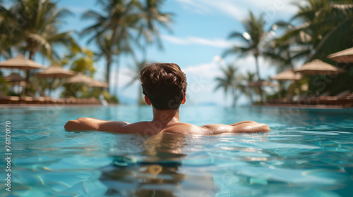 Young man relaxing in resort swimming pool. Generative ai  © Malaika