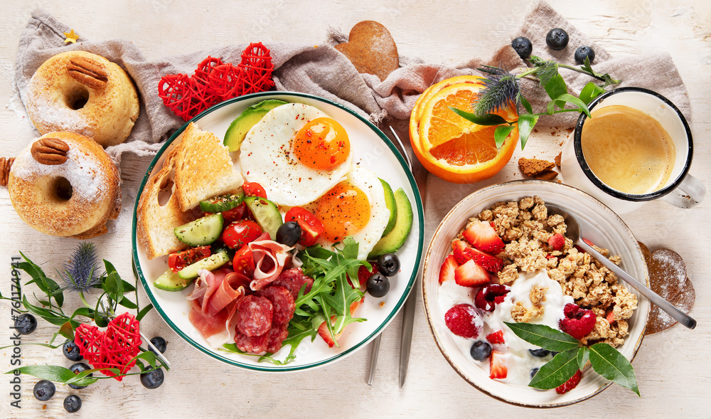 Healthy breakfast with oatmeal, berries, egg, bacon and a cup of coffee. Good morning