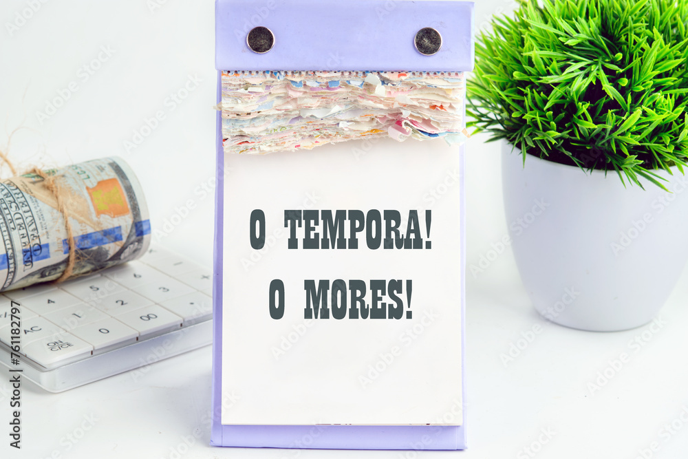 o tempora, o mores (O, the times O, the morals) Latin phrase on a piece of a desktop calendar with tear-off pages - obrazy, fototapety, plakaty 