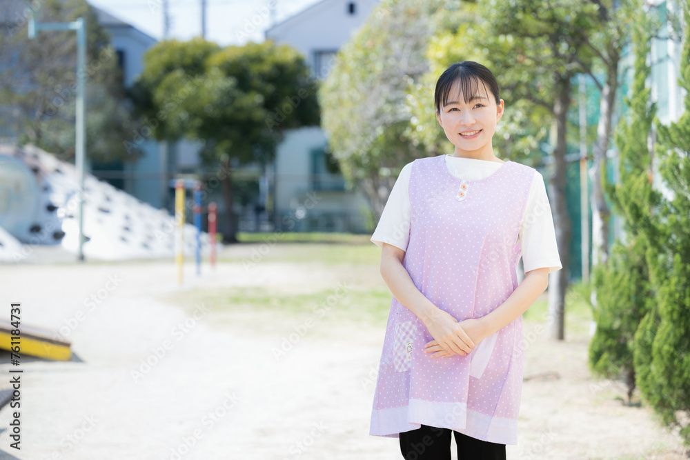 Greeting a preschooler Image of a childcare worker or caregiver smiling and looking at the camera Greeting a preschooler Image of a childcare worker or caregiver smiling and looking at the camera