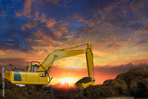 Crawler excavator with Bucket lift up are digging the soil in the construction site on the sunset sky backgrounds
