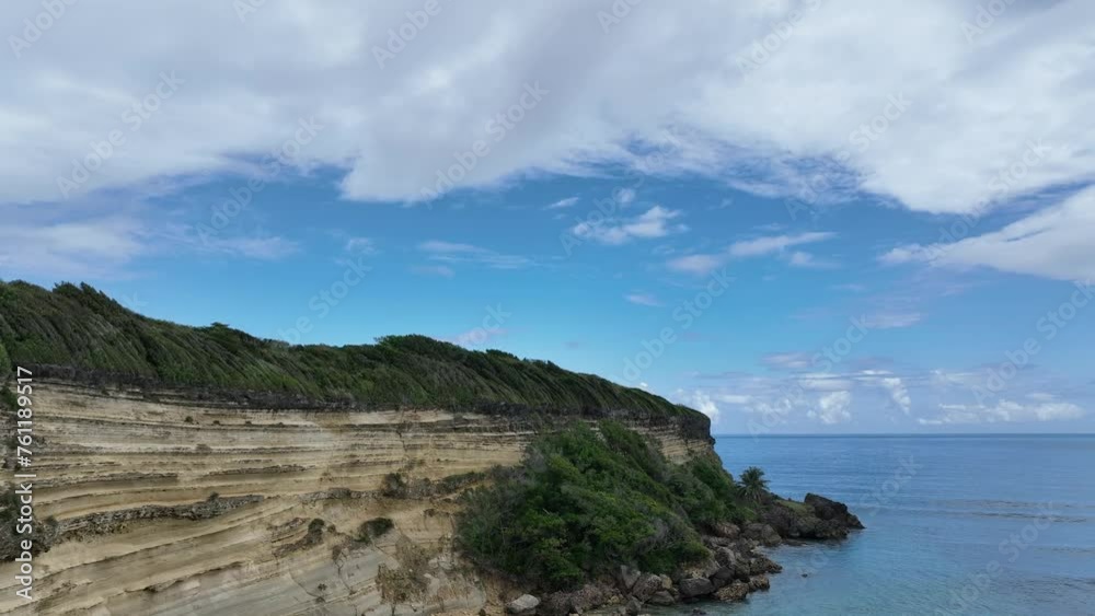 Rocky cliff of Playa Caleton beach in Dominican Republic. Aerial forward ascending and sky for copy space Rocky cliff of Playa Caleton beach in Dominican Republic. Aerial forward ascending and sky for copy space