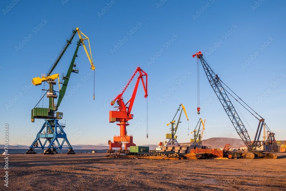 harbour cranes at the seaport against a clear blue sky
