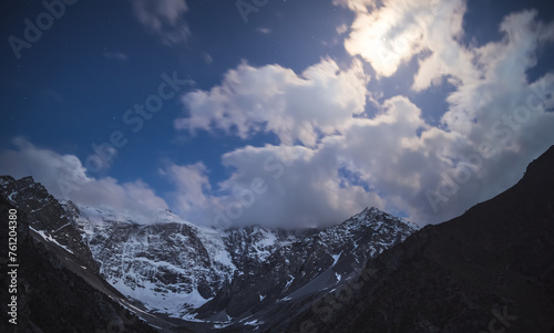 
Night landscape of a mountain range with rocks, snow and glaciers in the Fan Mountains in Tajikistan, Tien Shan highlands on a starry moonlit night