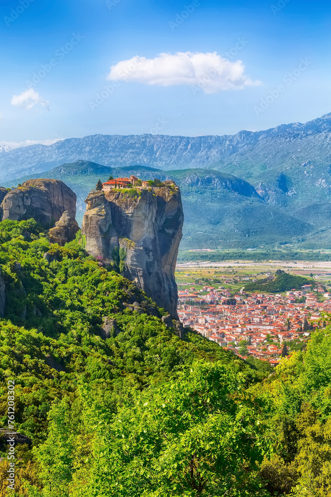 Panoramic view of Meteora monastery on the high rock and village in mountains at spring time, Greece