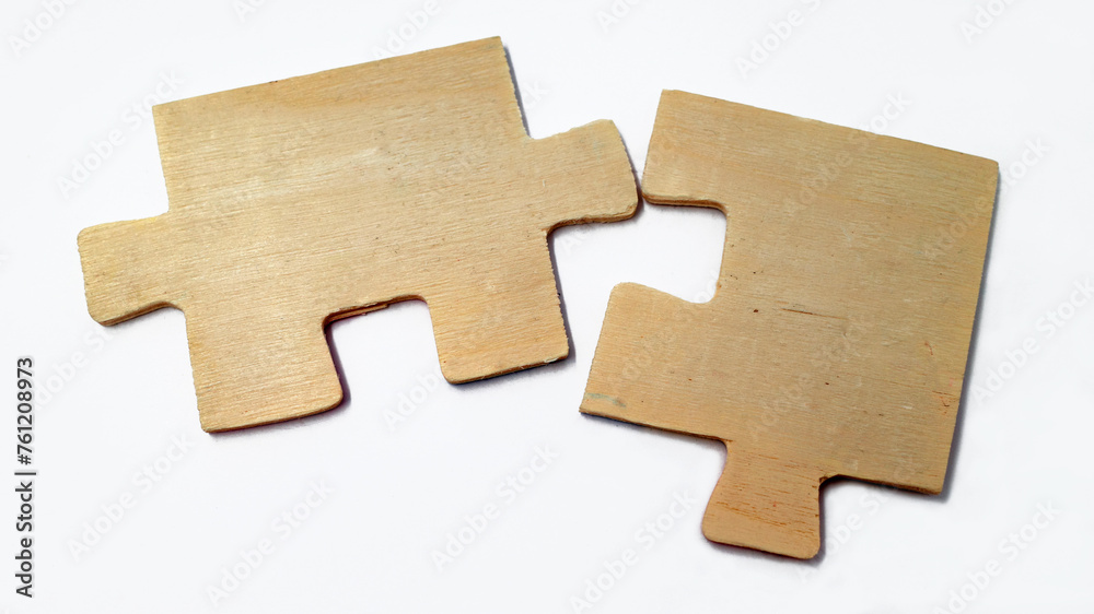 Fototapeta premium Fitting wooden puzzle pieces isolated on a white background