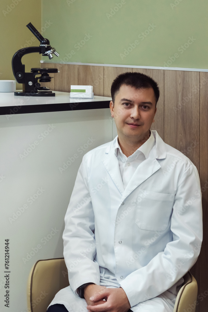 Man portrait of a doctor wearing a white coat, looking into the camera, copy space, space for text, health concept