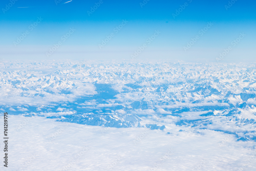 An aerial view of the Alps, a European mountain range and also the highest and most extensive mountain range that is entirely in Europe, stretching approximately 1,200 km across eight Alpine countries