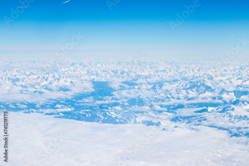 An aerial view of the Alps, a European mountain range and also the highest and most extensive mountain range that is entirely in Europe, stretching approximately 1,200 km across eight Alpine countries