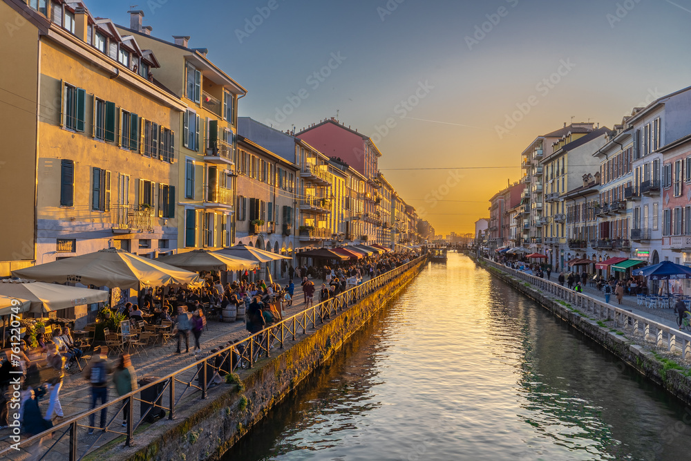 Obraz premium Milan, Italy 03-07-2024 The navigli are a system of interconnected canals in and around Milan and now known for its quirky charm and lively nightlife scene with bars and restaurants during sunset