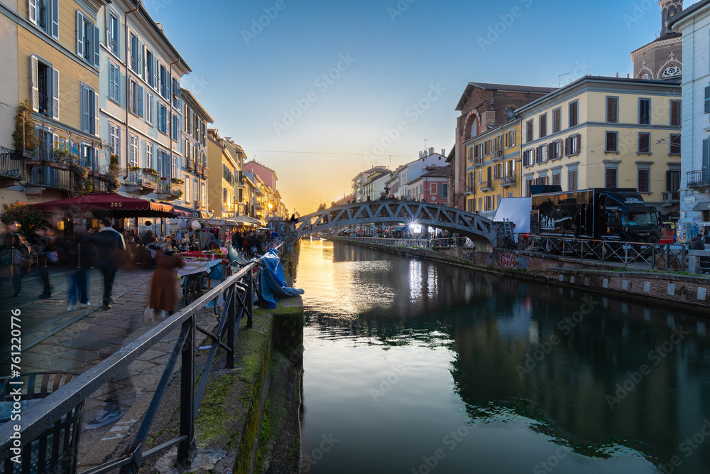 Fototapeta premium Milan, Italy 03-07-2024 The navigli are a system of interconnected canals in and around Milan and now known for its quirky charm and lively nightlife scene with bars and restaurants during sunset