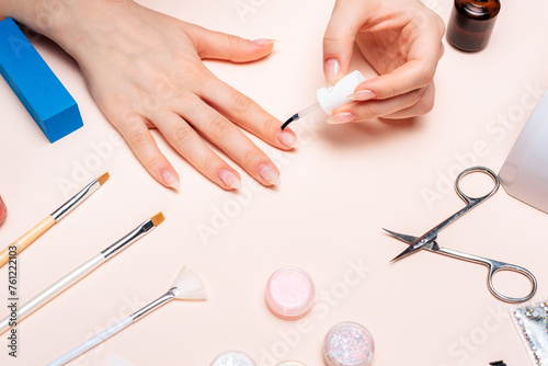 a girl doing a manicure at home, hands close-up. the view from the top