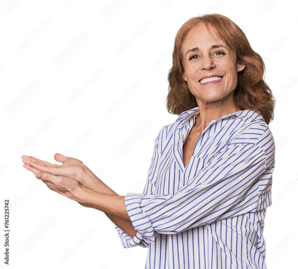 Redhead mid-aged Caucasian woman in studio holding a copy space on a palm. Redhead mid-aged Caucasian woman in studio holding a copy space on a palm.