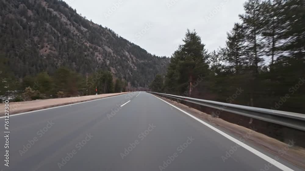 Dash Cam POV Car Driving Down Asphalt Road Through Austrian Alps Valley on Cloudy Day Dash Cam POV Car Driving Down Asphalt Road Through Austrian Alps Valley on Cloudy Day