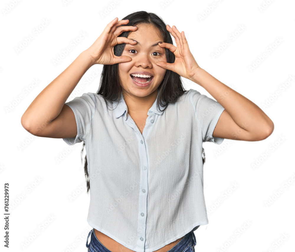 Young chinese woman isolated keeping eyes opened to find a success opportunity. Young chinese woman isolated keeping eyes opened to find a success opportunity.