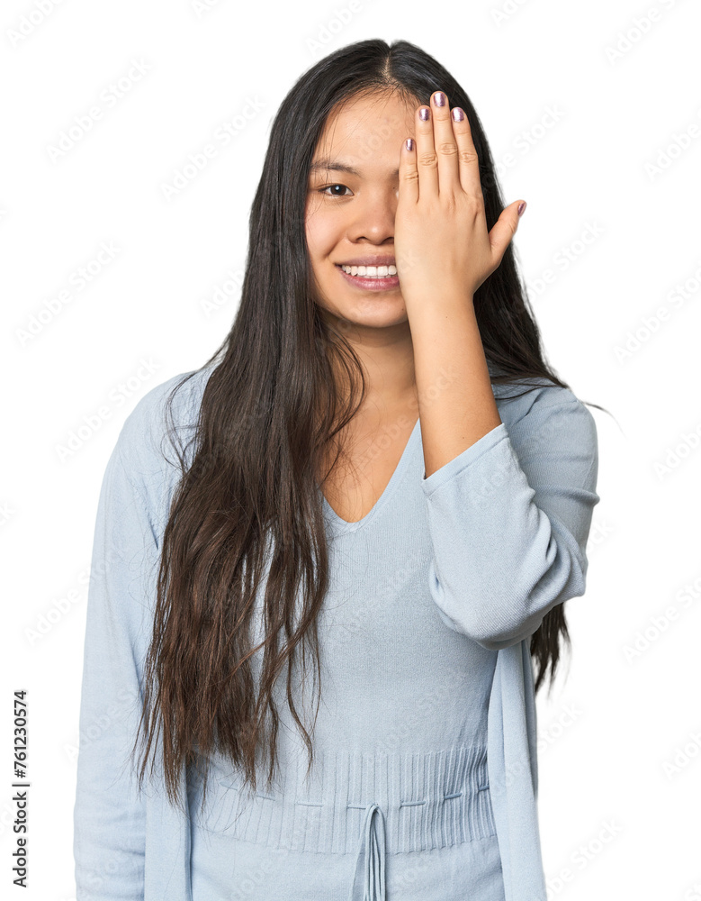 Young chinese woman isolated having fun covering half of face with palm. Young chinese woman isolated having fun covering half of face with palm.