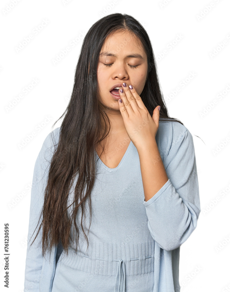 Young chinese woman isolated yawning showing a tired gesture covering mouth with hand. Young chinese woman isolated yawning showing a tired gesture covering mouth with hand.