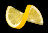Twisted lemon slice on black background, full depth of field