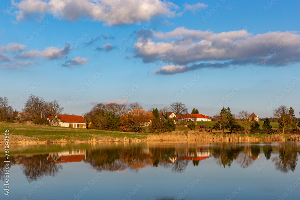 Evening over village on a lake bank. Early springtime. Evening over village on a lake bank. Early springtime.