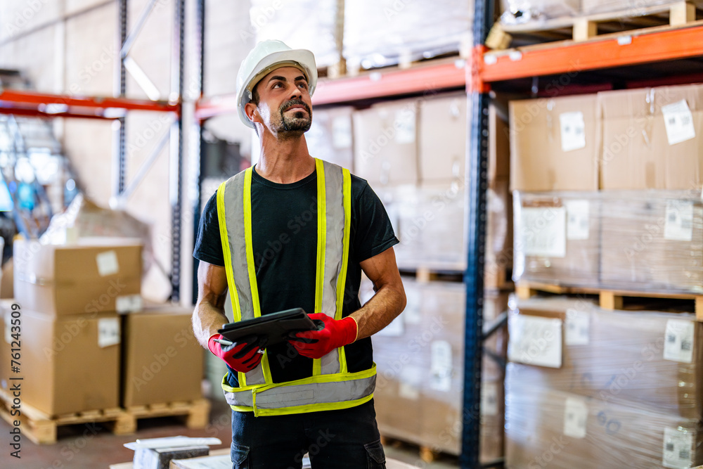 Smiling worker examining inventory with tablet PC at warehouse Smiling worker examining inventory with tablet PC at warehouse