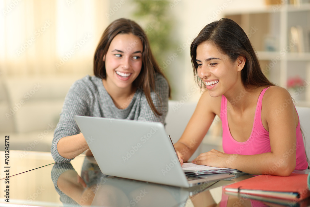 Private teacher teaching to a happy student at home Private teacher teaching to a happy student at home