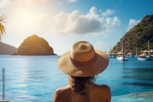 Summer day woman relaxing near the sea on the beach of an open air resort hotel. Tourism, summer vacation concept