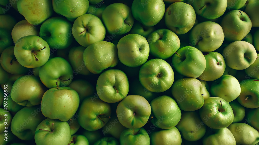 Fresh dew adorns a pile of vibrant green apples, suggesting a bountiful harvest. Fresh dew adorns a pile of vibrant green apples, suggesting a bountiful harvest.