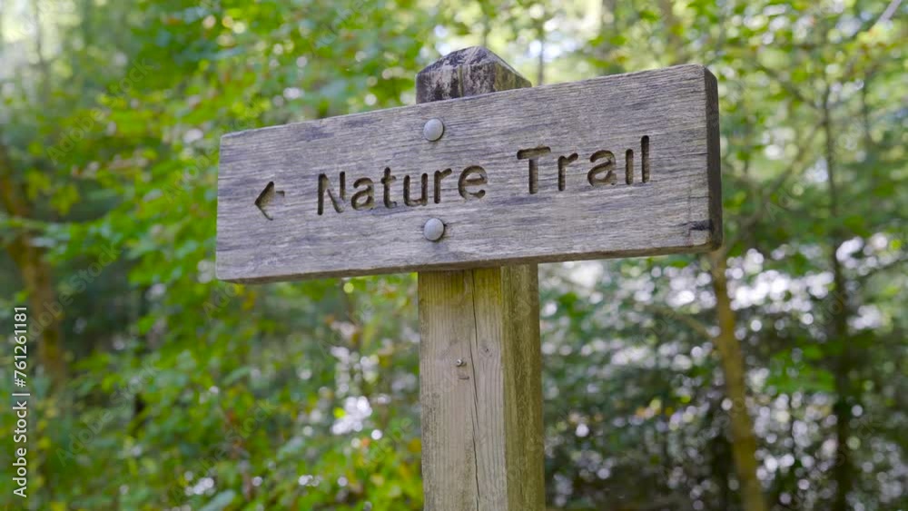 Low Angle Sign showing direction of the nature trail Close Up Low Angle Sign showing direction of the nature trail Close Up