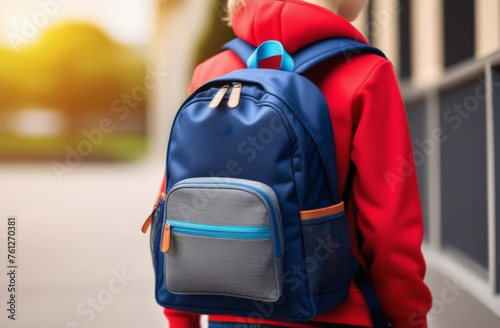 schoolboy boy goes to school in the morning. happy child with a briefcase on his back, free text, space for copy. Back view