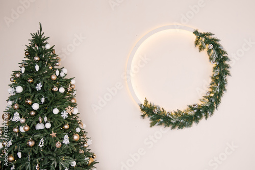 Obraz na płótnie Stylish Christmas wreath with backlight on a white wall background, New Year decor, empty space for text w salonie