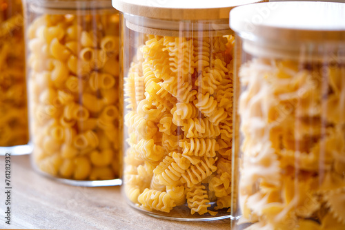 Close-up of pasta in glass jars. Healthy grains and pasta food selection. Close up shot of glass containers containing different kinds of pasta